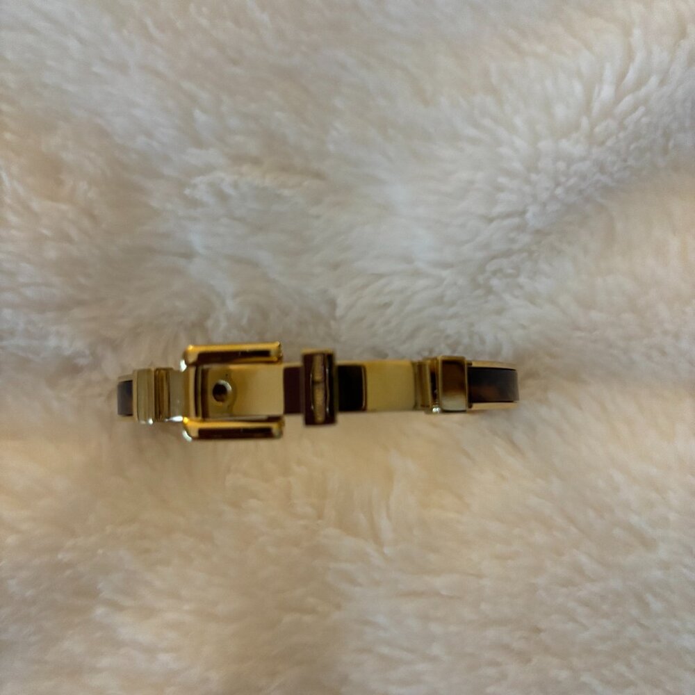 Michael Kors tortoise and gold bangle bracelt. Approx. 7 inches in diameter